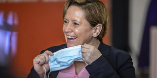 Susanne Eisenmann lacht und nimmt ihre Mundschutzmaske vom Gesicht
