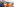 Nouiripour schuat auf Materialine von 2 Katastrophenschützern mit Atemschutzmasken und orangen Anzügen