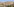 Blick auf die Landschaft bei Jerusalem, im Vordergrund ein palästinensischer Ort, Sonne scheint auf sandige Landschaft, eine Mauer trennt Siedlungsbereiche